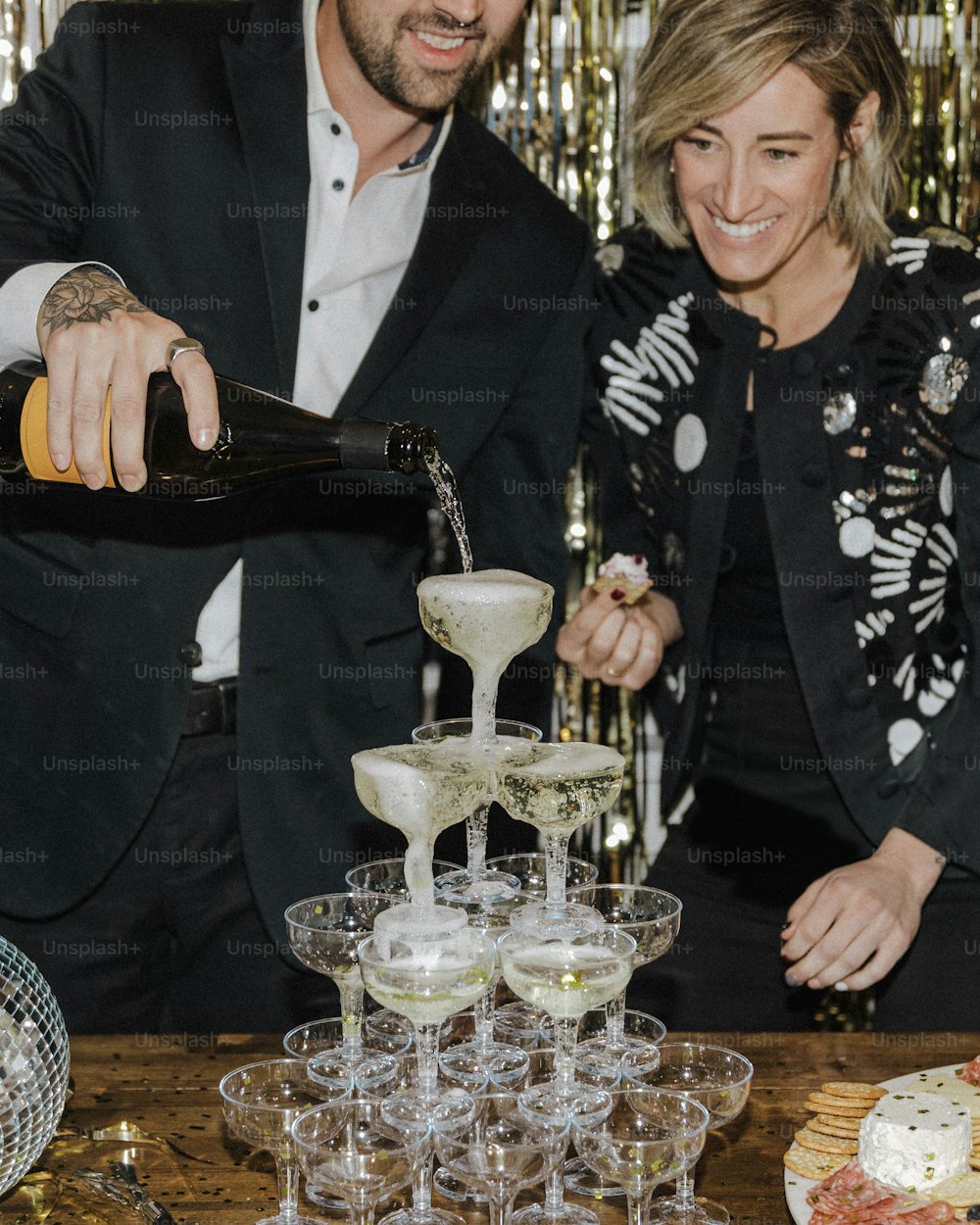 a man and a woman pouring champagne into wine glasses