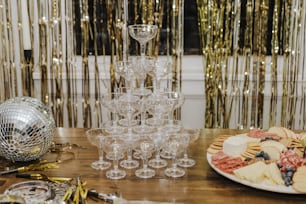 a table topped with a plate of food and wine glasses
