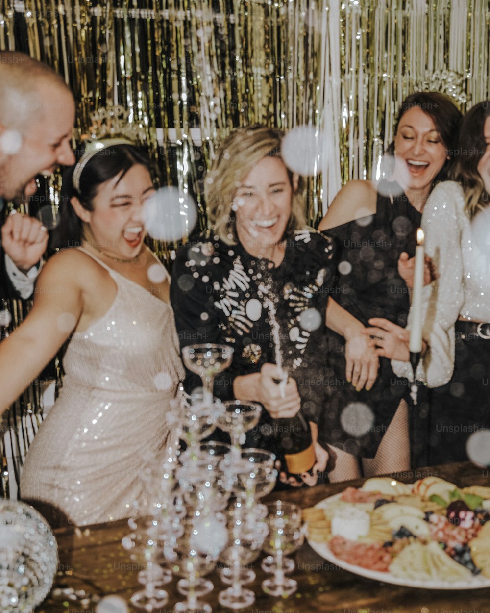 a group of people standing around a table