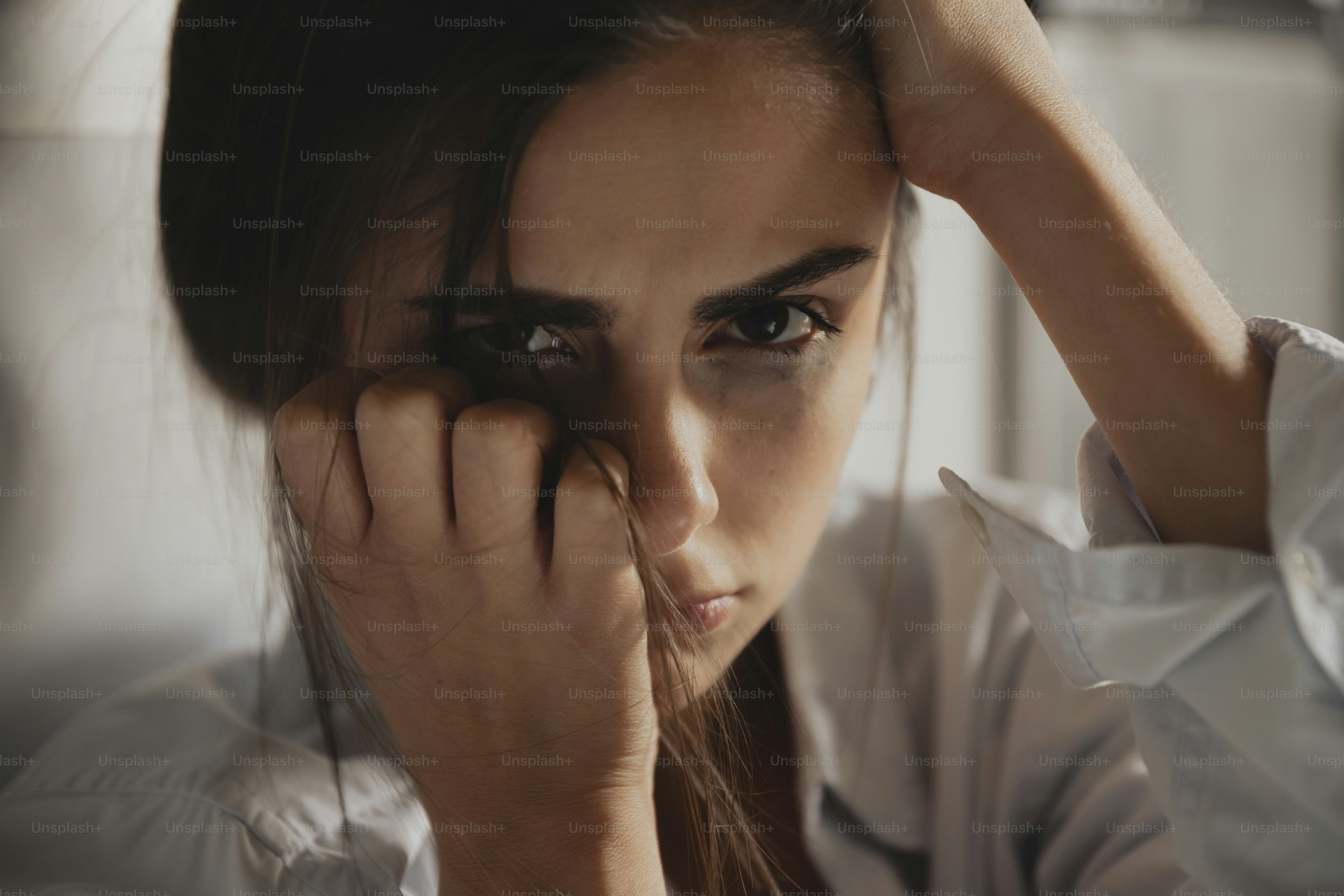 a woman holding her hand to her face