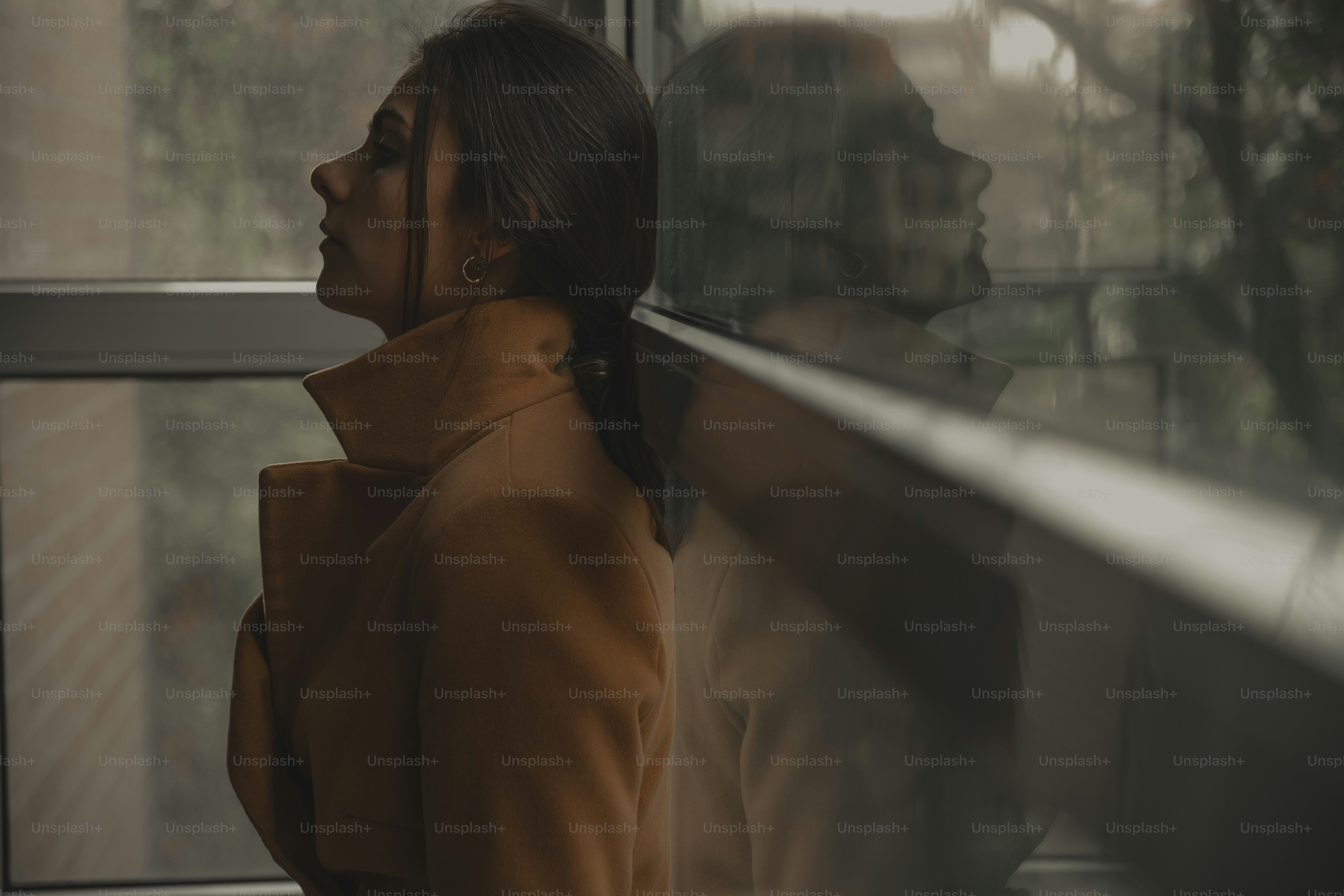 a woman standing in front of a window