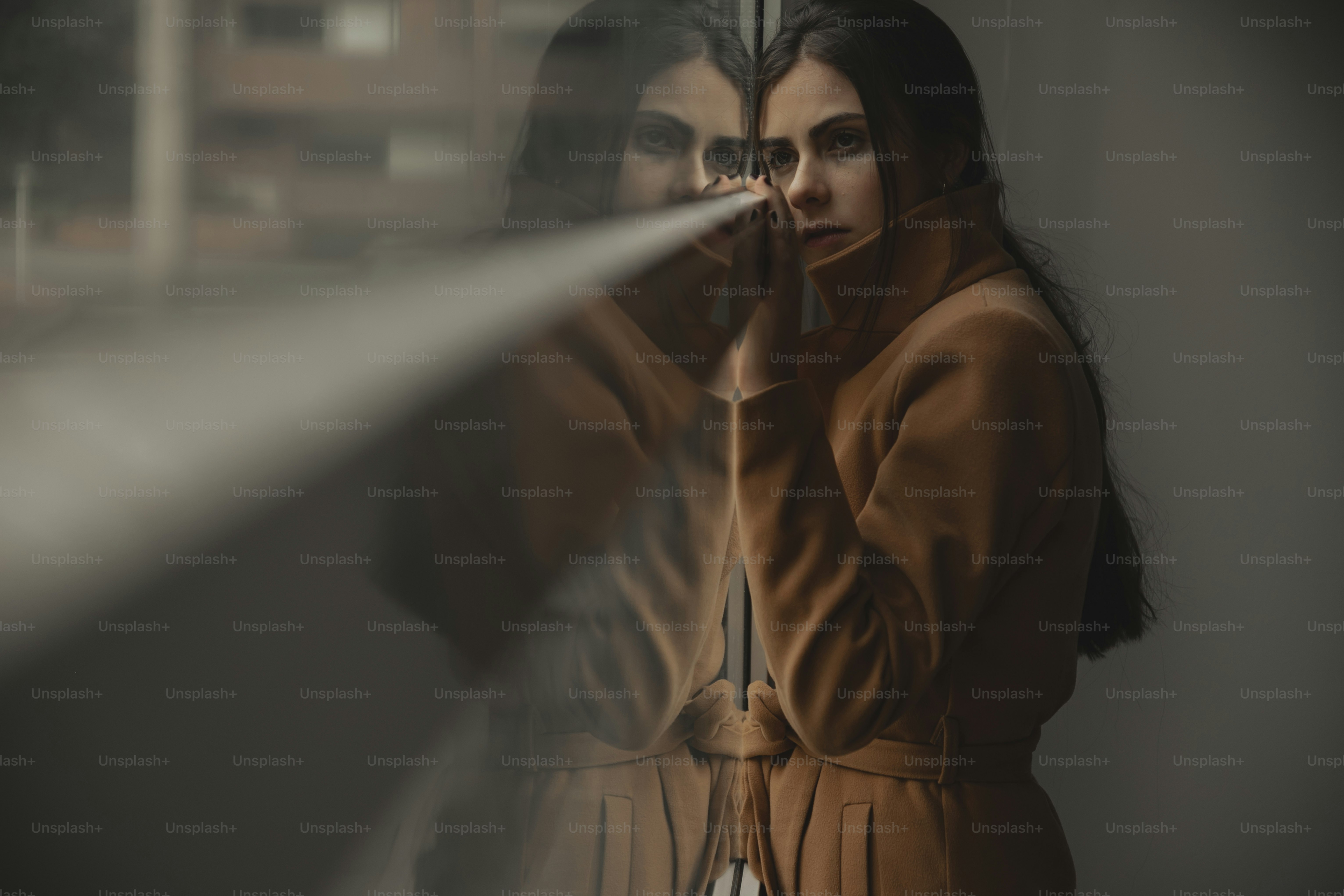 a woman standing in front of a window