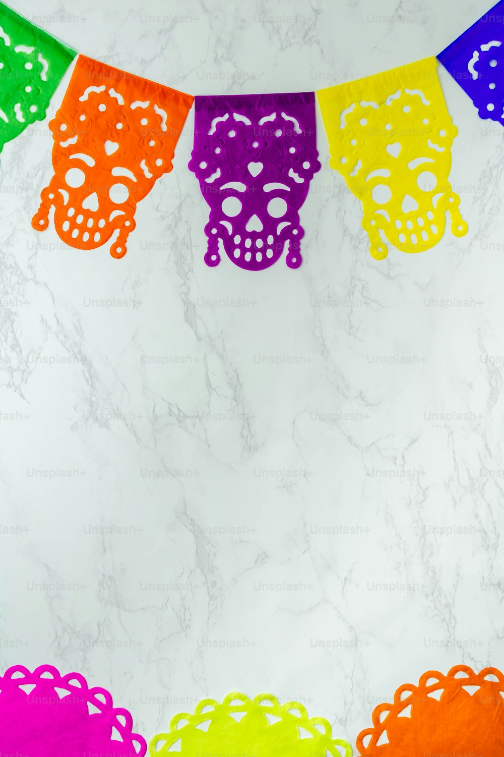 a colorful day of the dead banner on a marble wall