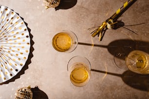 a table topped with glasses of yellow liquid