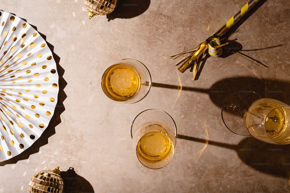 a table topped with glasses of yellow liquid