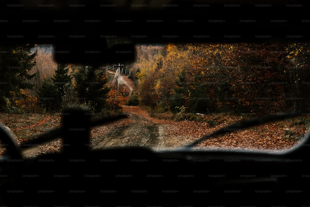 a view from inside a vehicle of a dirt road