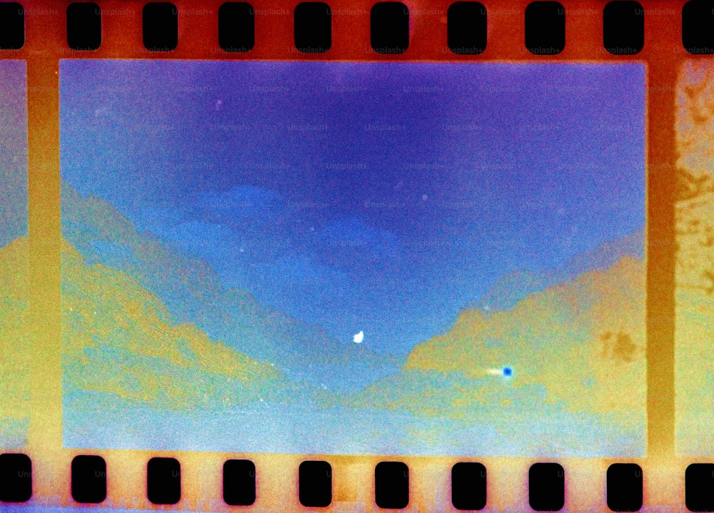 A polaroid film strip with a blue sky in the background photo