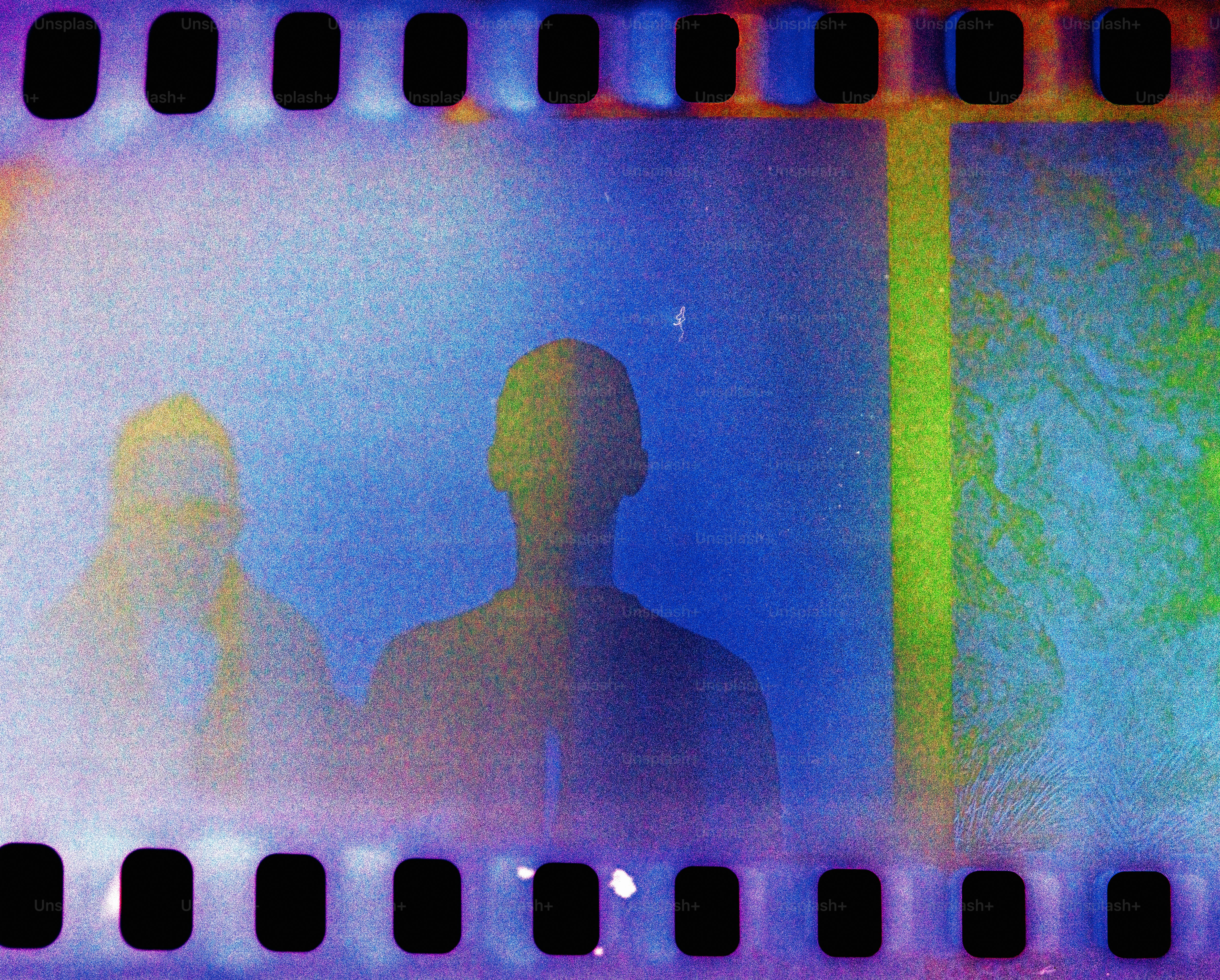 a man standing in front of a yellow and blue background