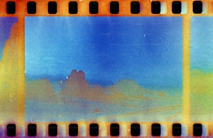 a film strip with a picture of mountains in the background