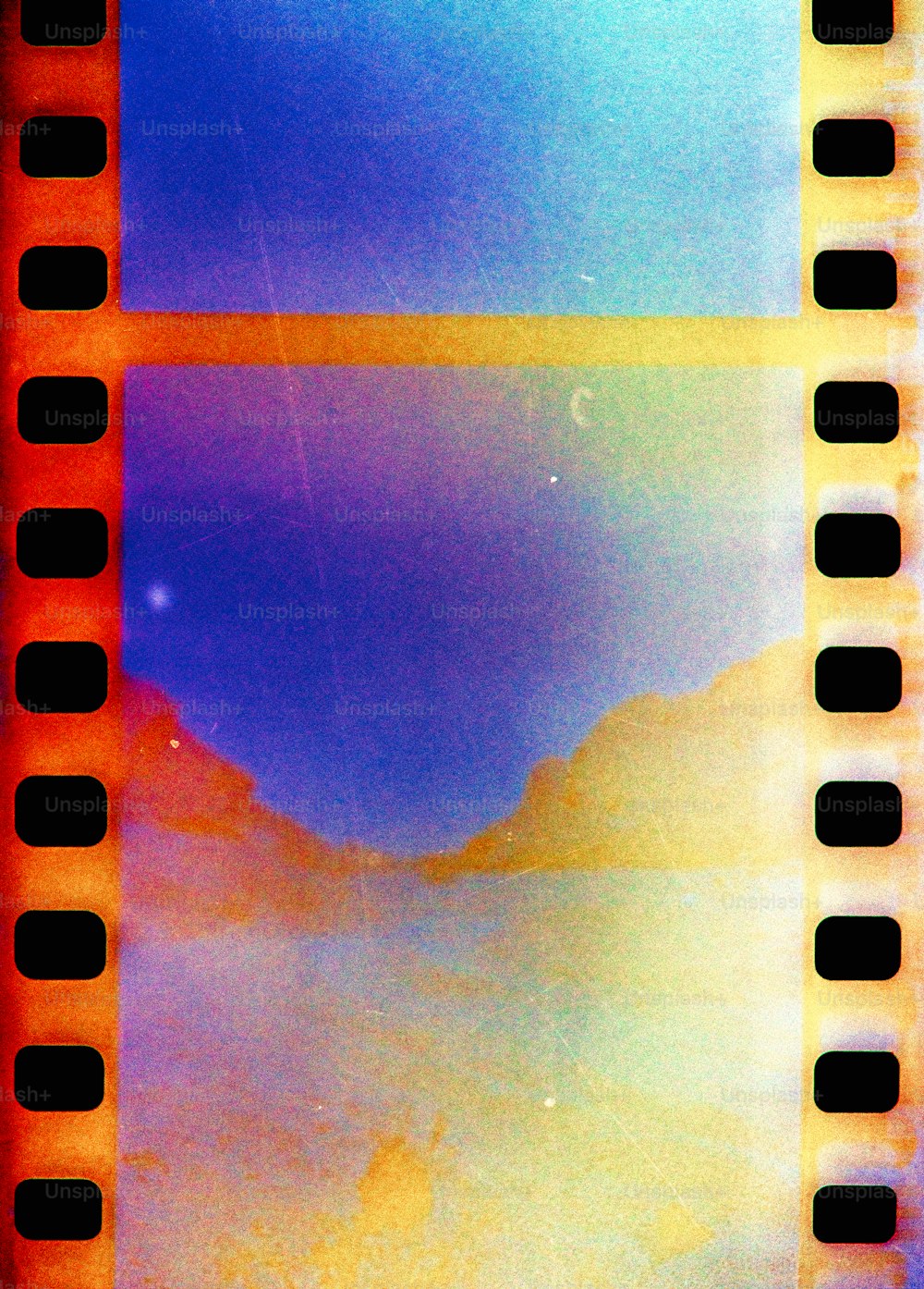 a close up of a film strip with a sky in the background