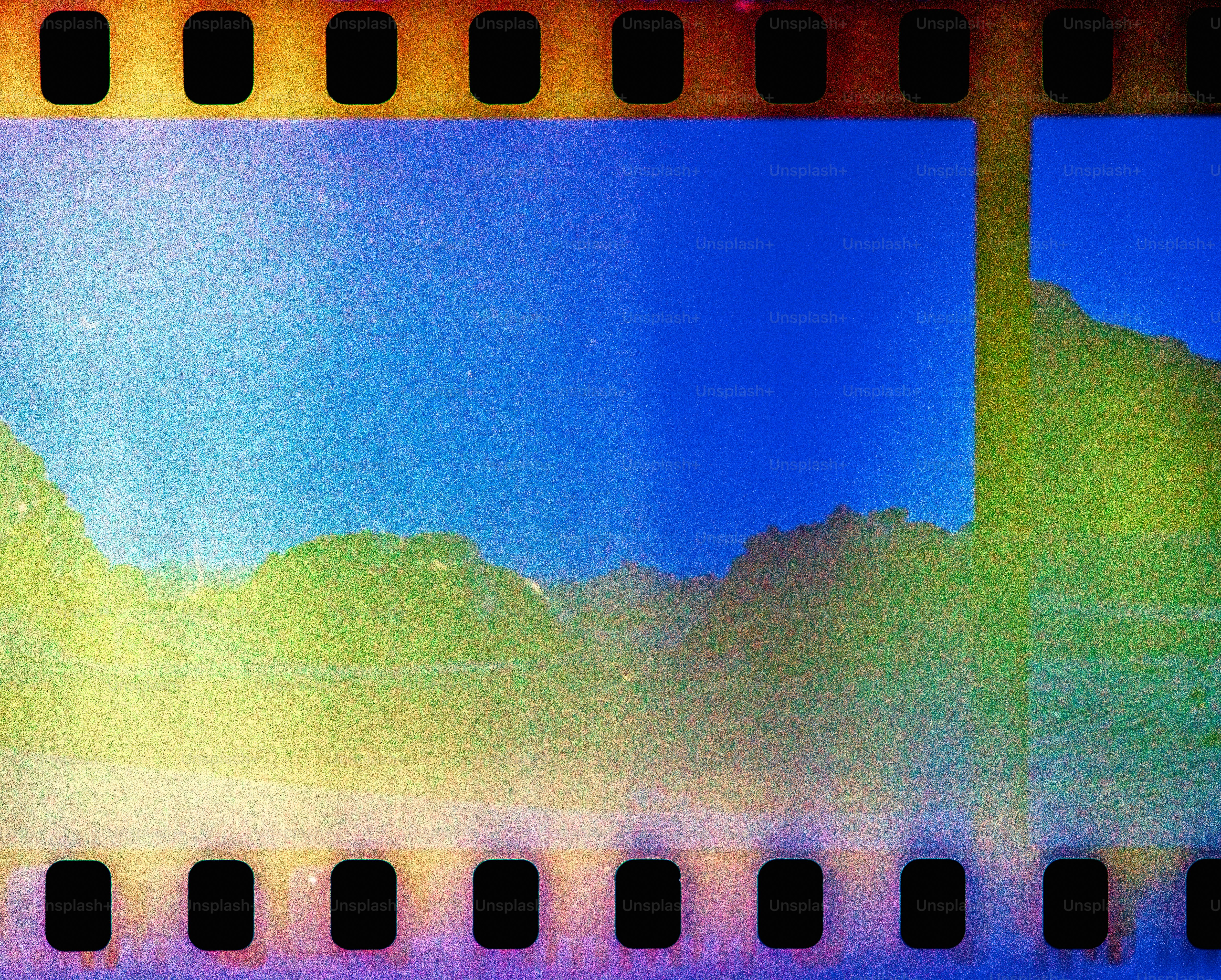 a yellow and blue film strip with a sky in the background