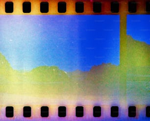 a yellow and blue film strip with a sky in the background
