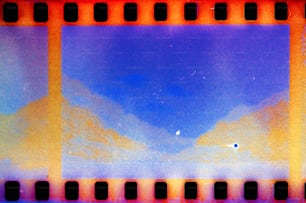 a film strip with a blue sky and mountains in the background