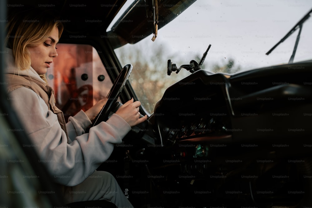 a woman sitting in the drivers seat of a truck