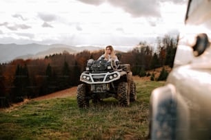 a woman sitting on top of a four wheeler