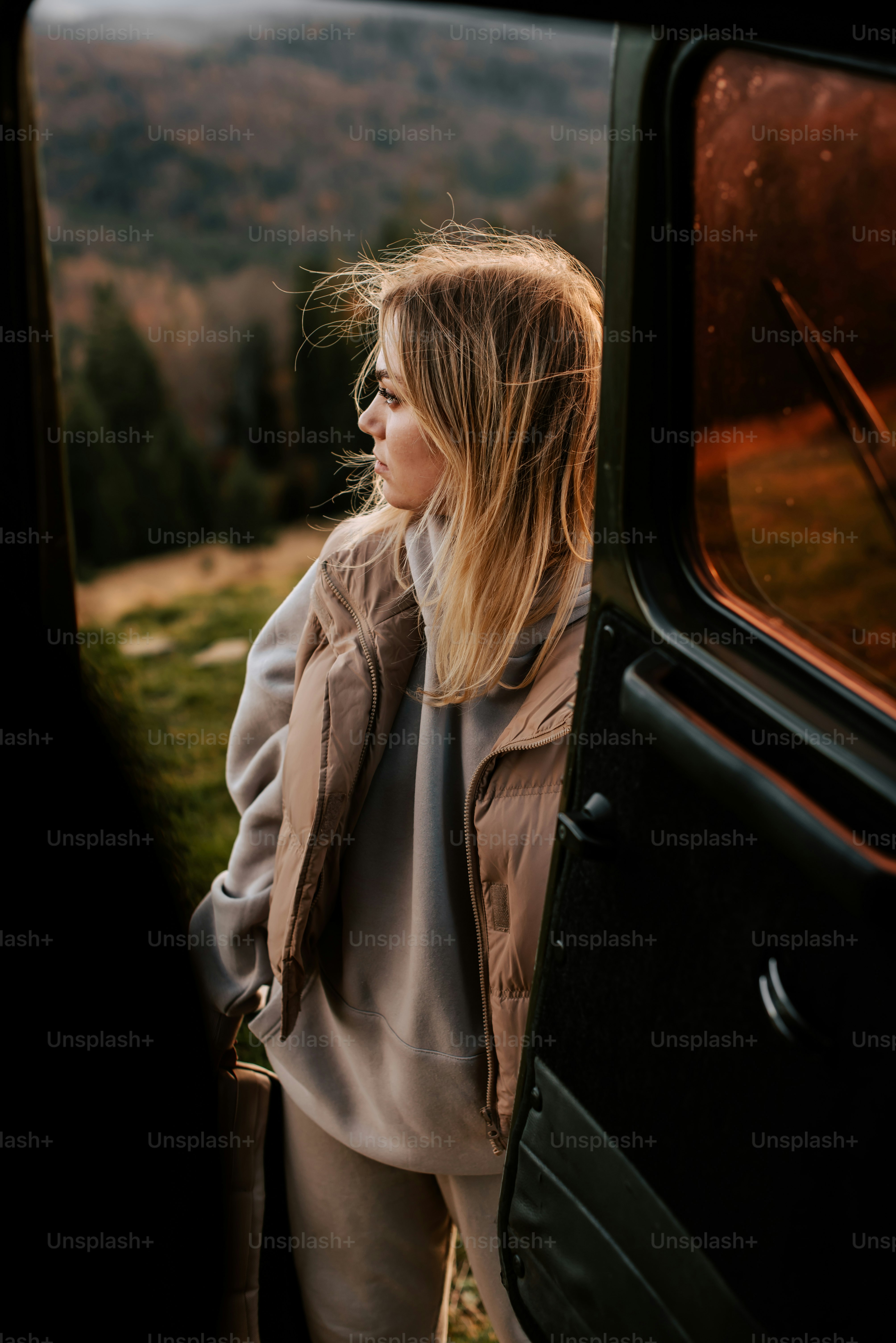 a woman looking out the window of a vehicle