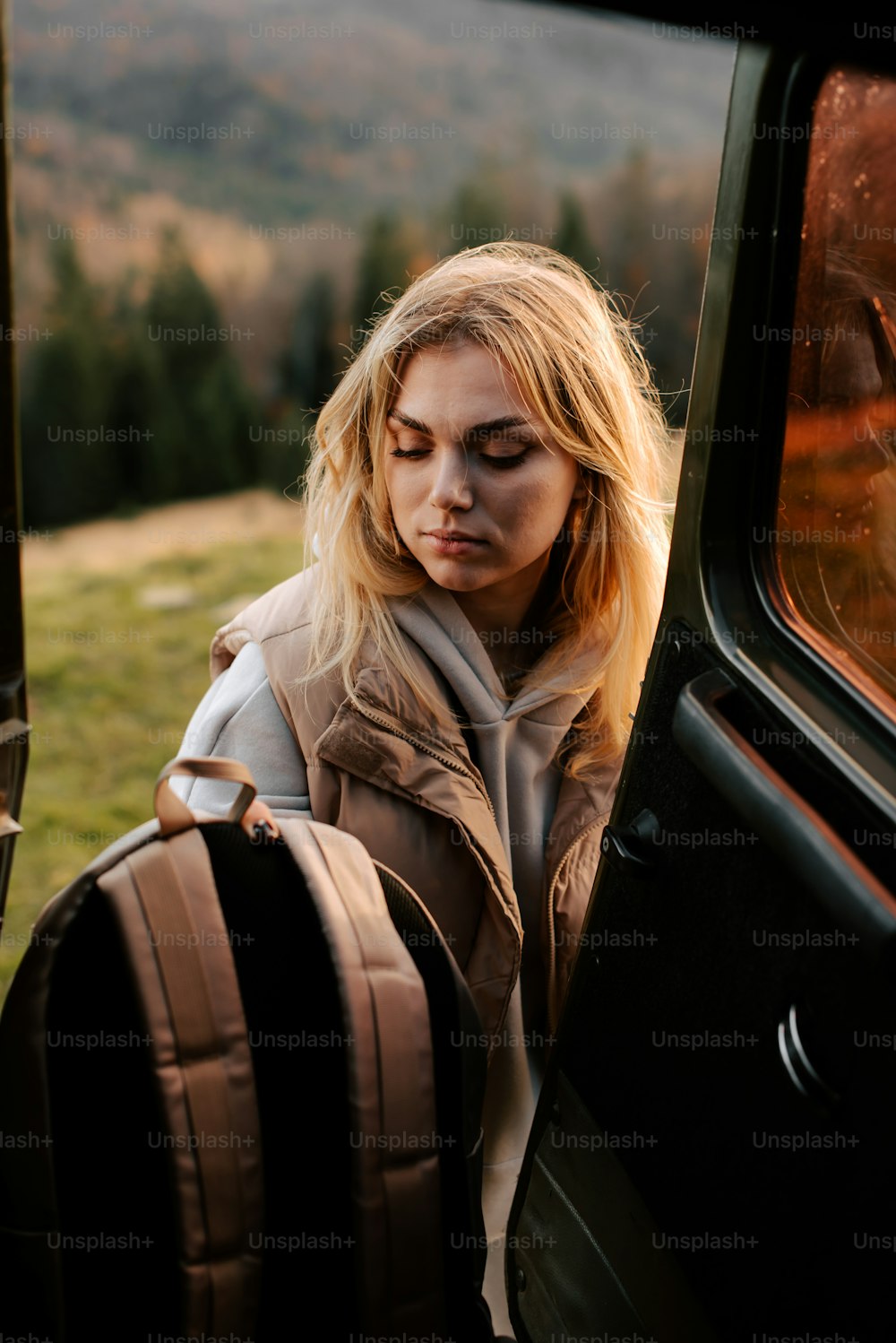 a woman is looking out the window of a vehicle