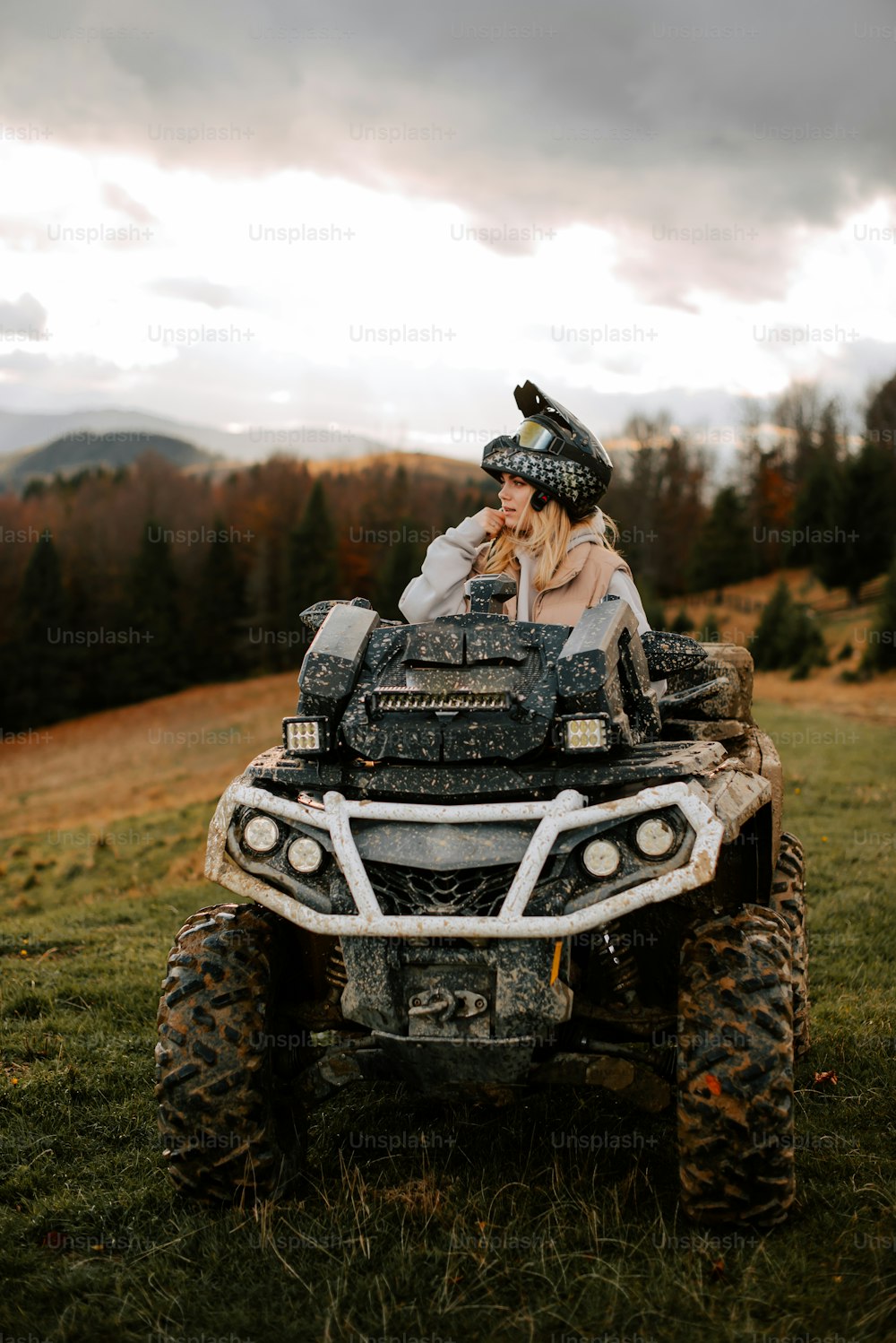a woman sitting on top of a four wheeler