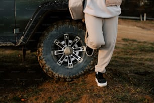 a man standing next to a green truck