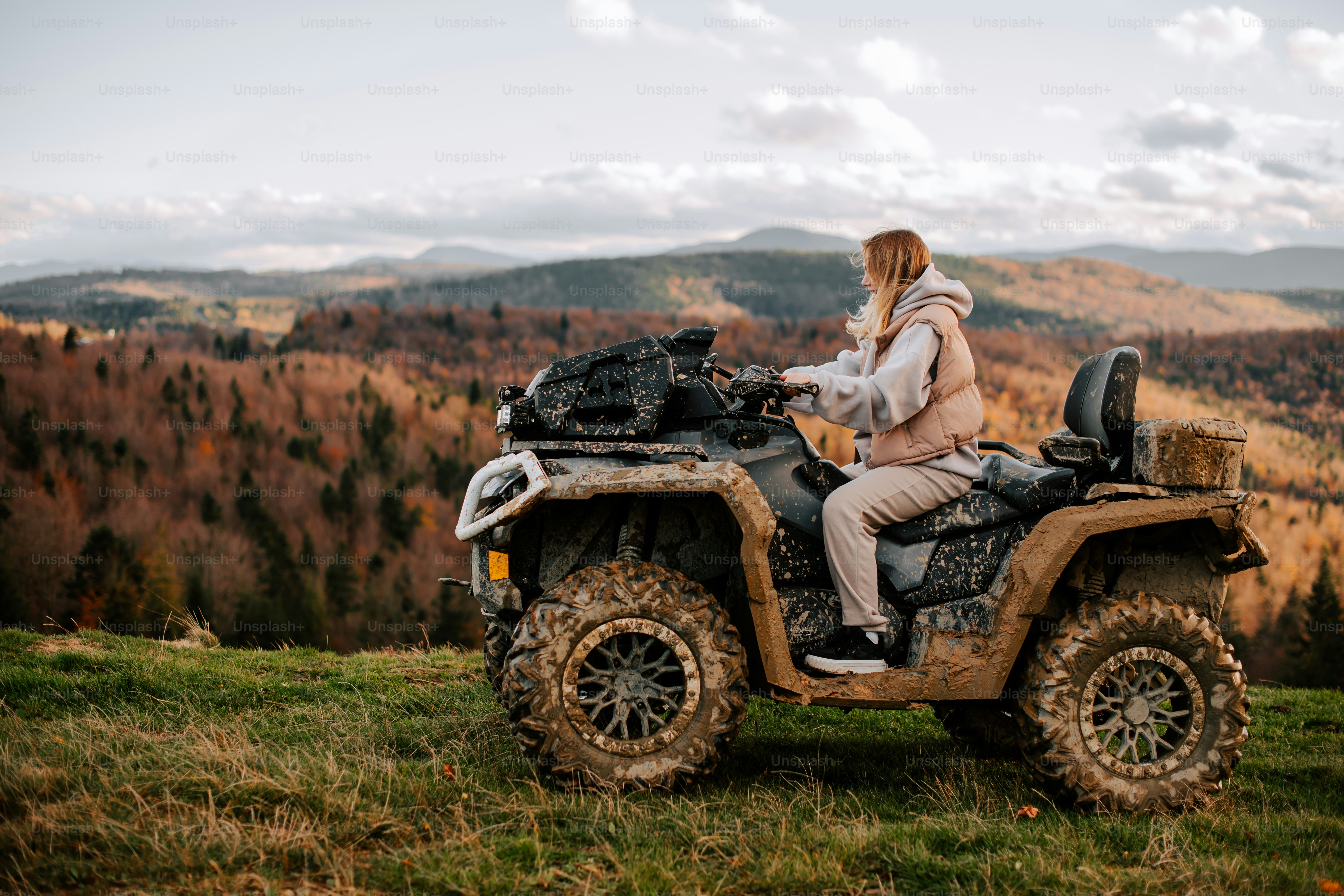 a woman riding on the back of an atv