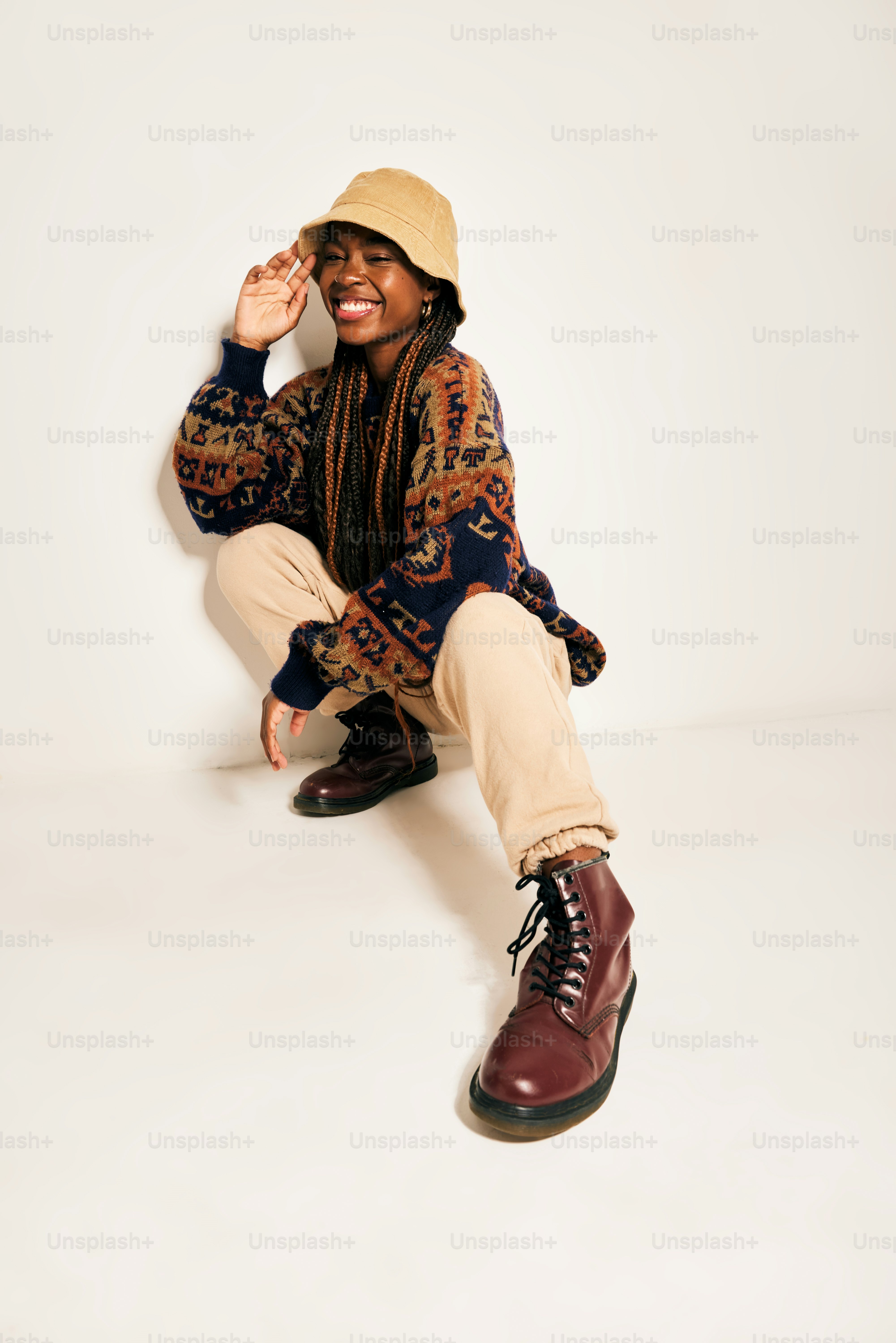 A man sitting on the ground wearing a hat photo – Portrait Image on ...