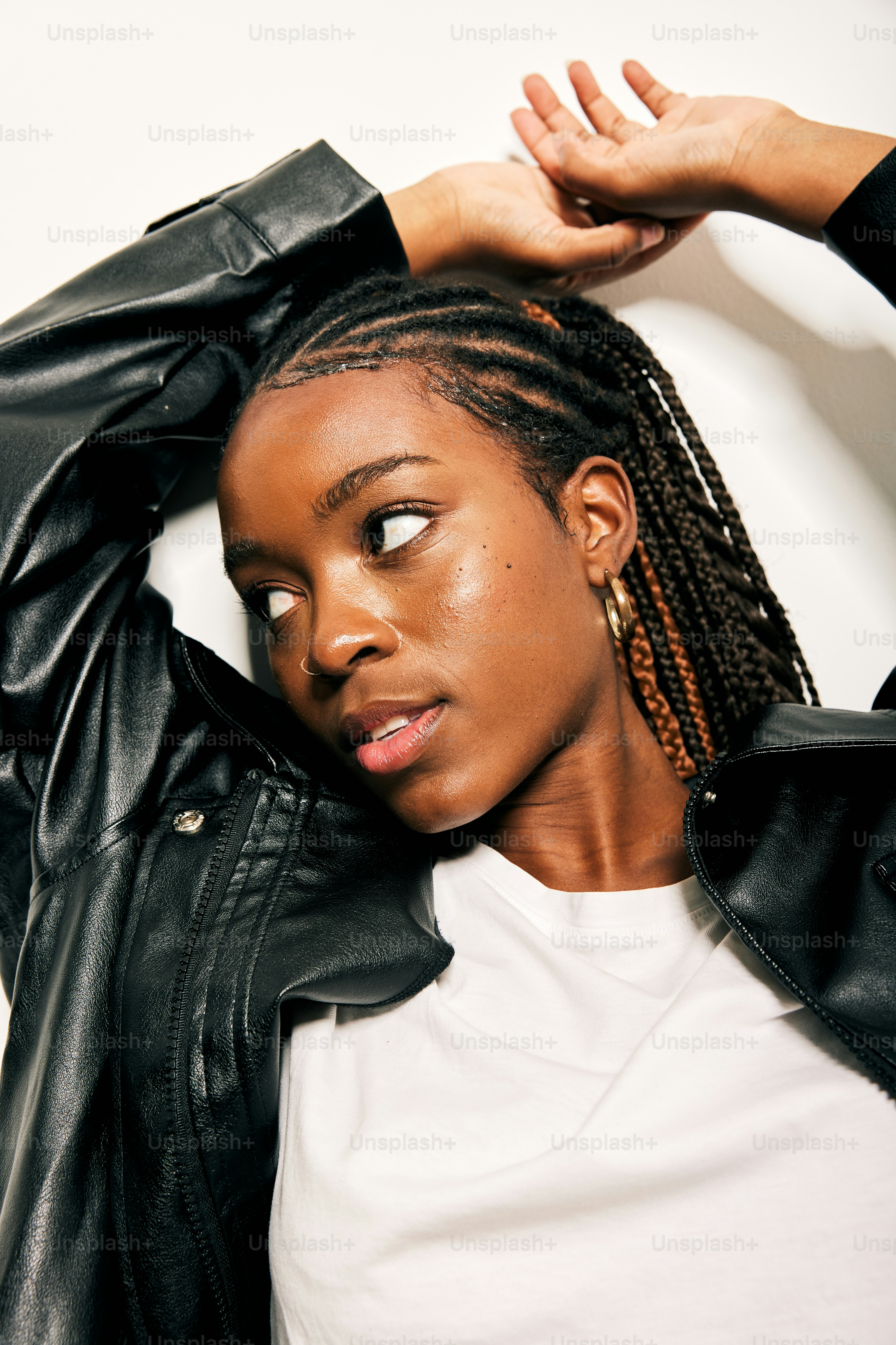 A woman sitting on the ground wearing a black jacket photo – Fashion ...