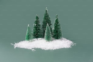 a group of small trees sitting on top of a pile of snow