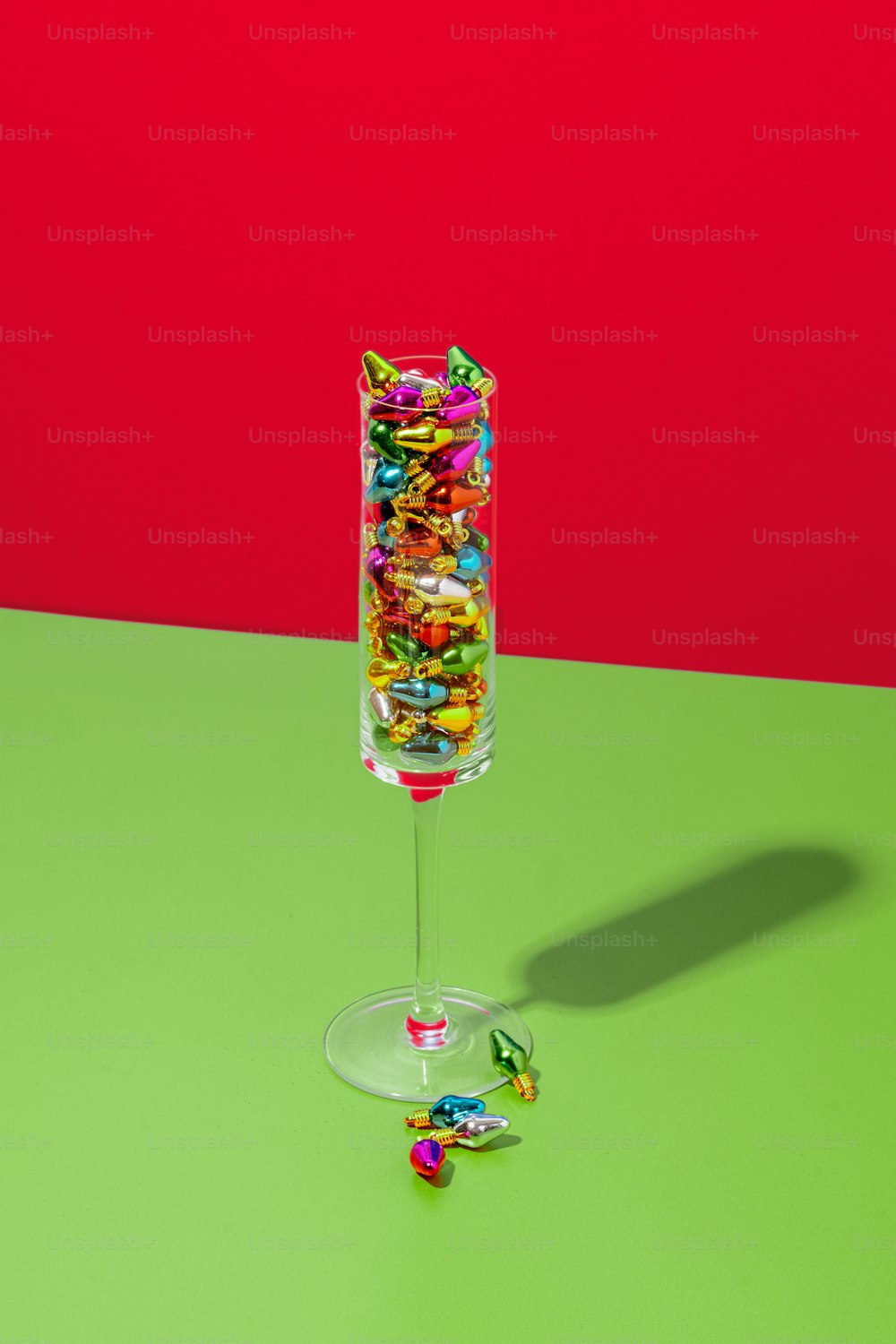 a glass filled with candy sitting on top of a table