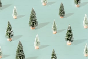 a group of small christmas trees sitting on top of a table