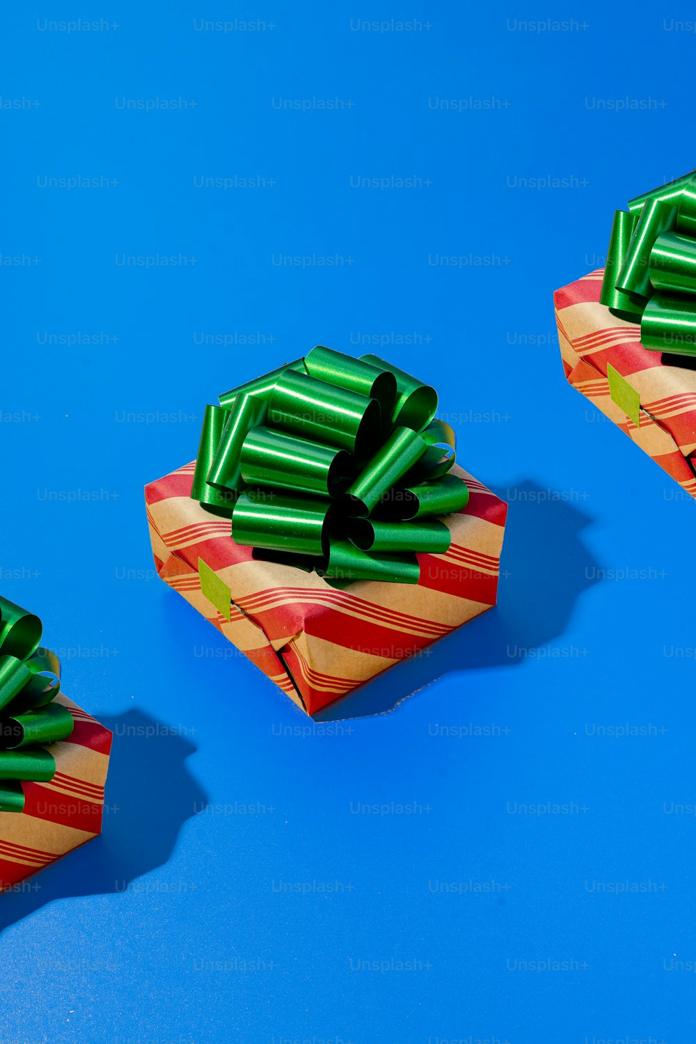 two wrapped presents sitting on top of a blue surface
