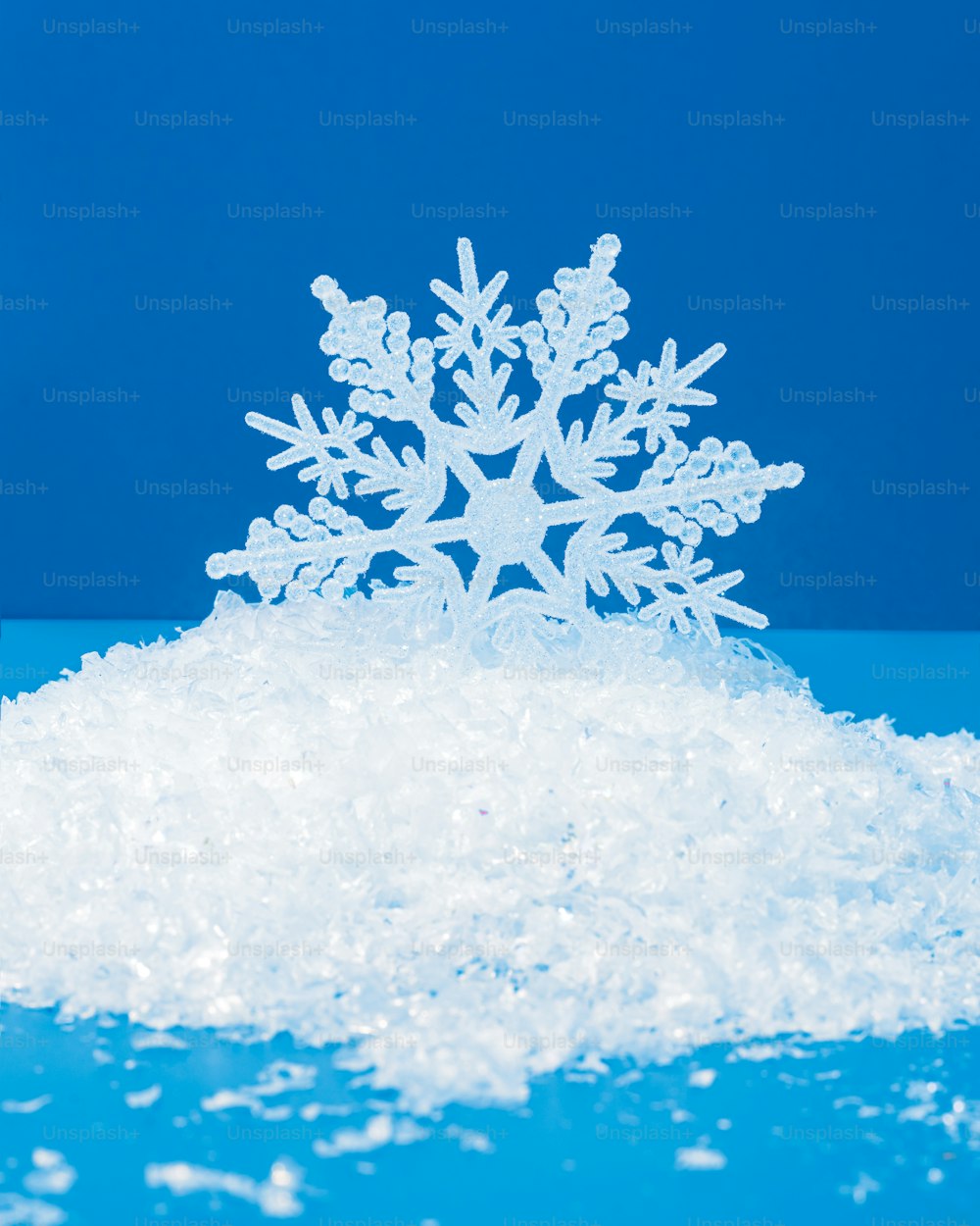 a snowflake is sitting on a pile of snow