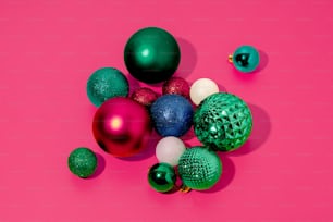 a group of christmas ornaments on a pink background