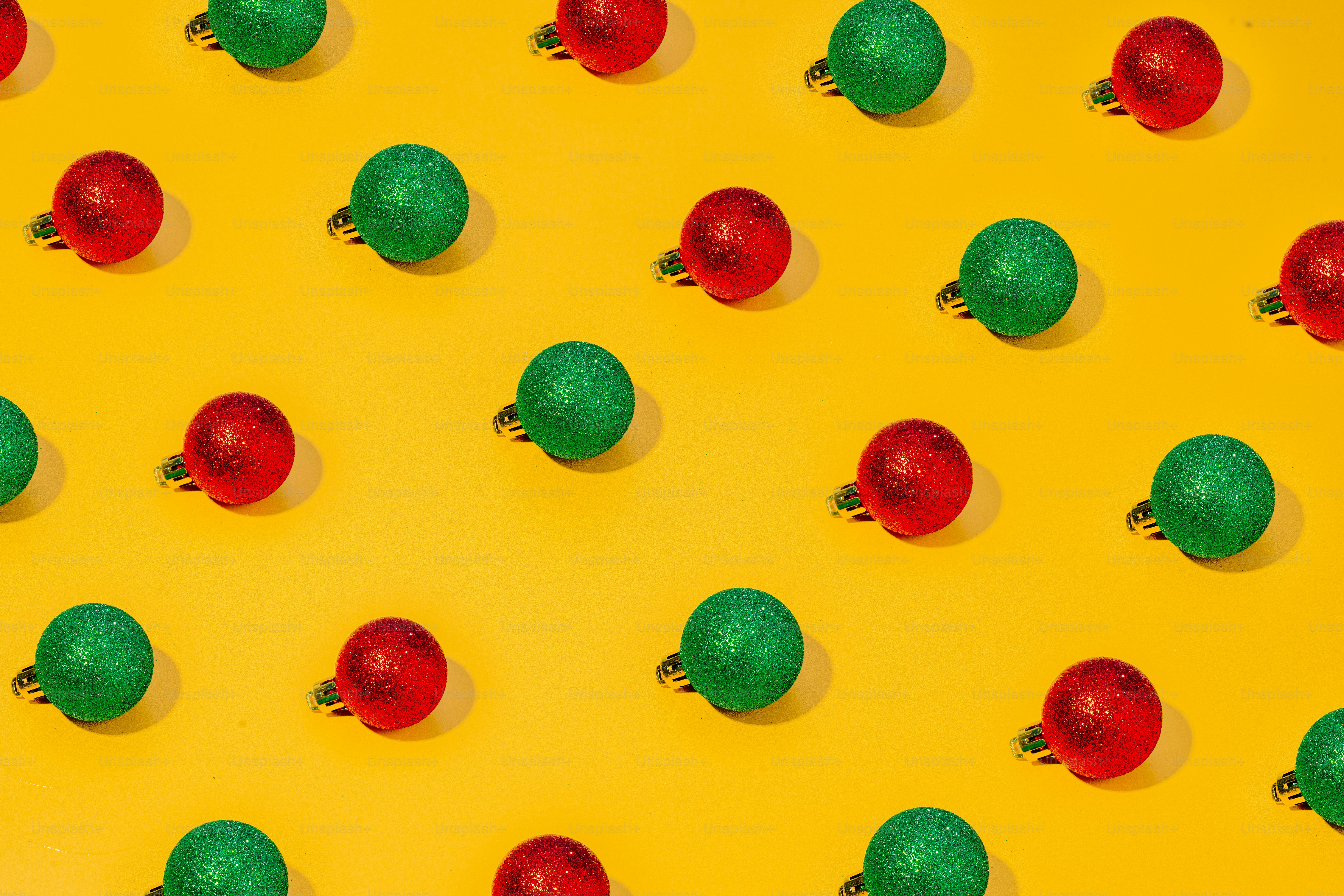 a group of green and red balls on a yellow background