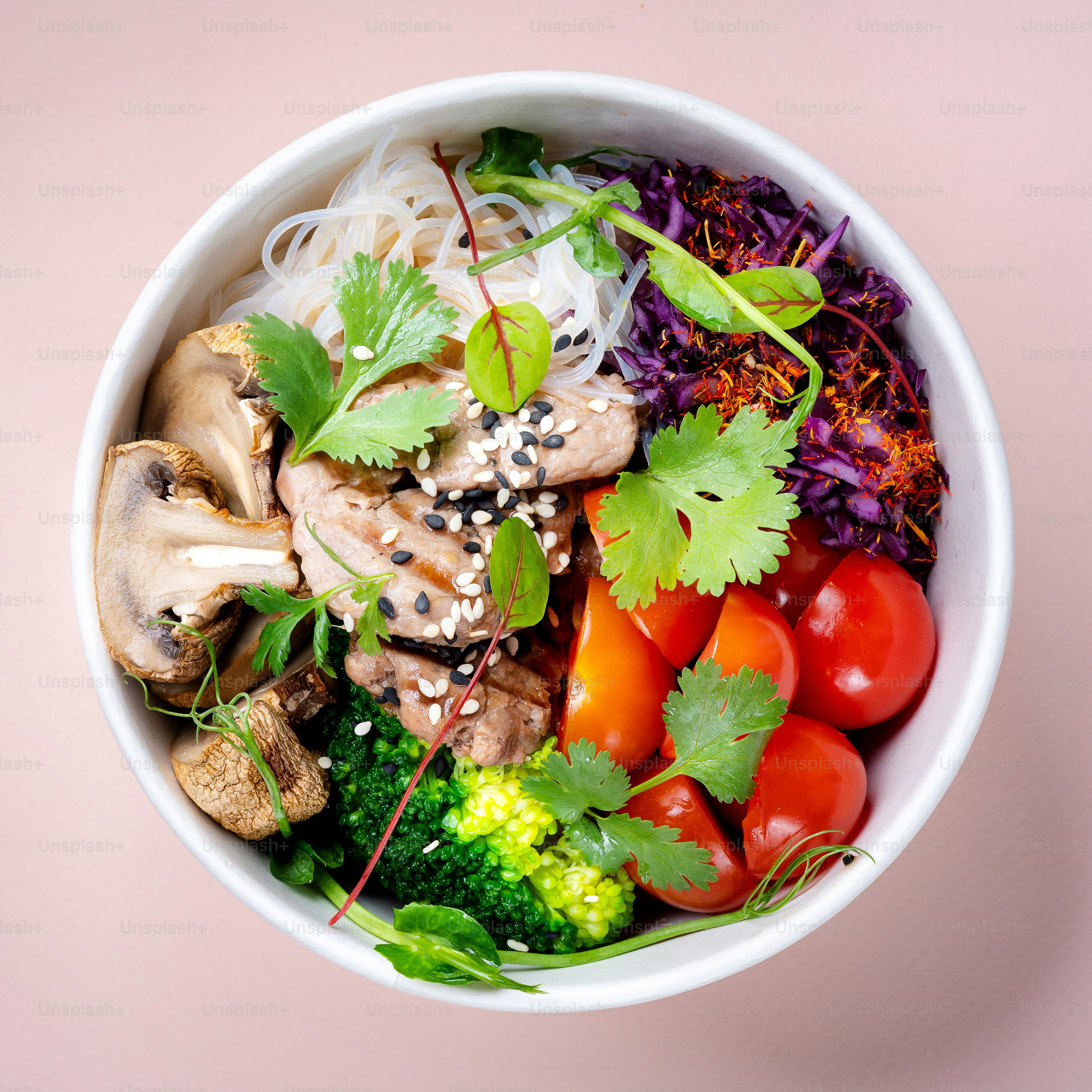 a white bowl filled with vegetables and meat
