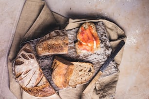 a loaf of bread and a piece of salmon on a table