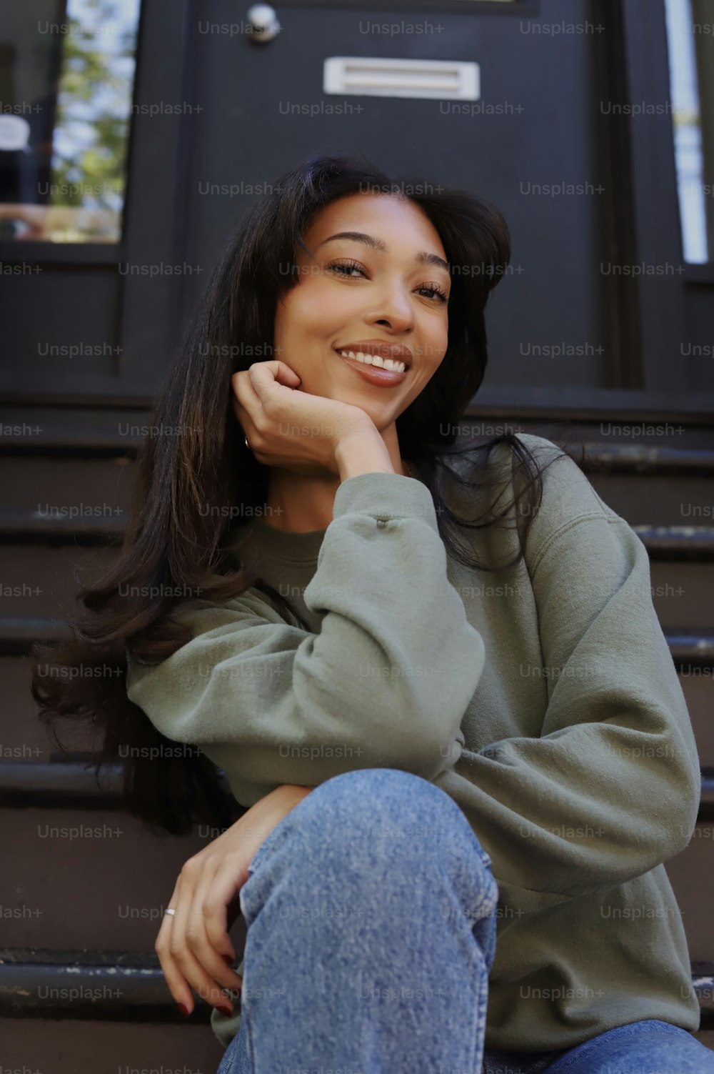 a woman sitting on the steps of a building