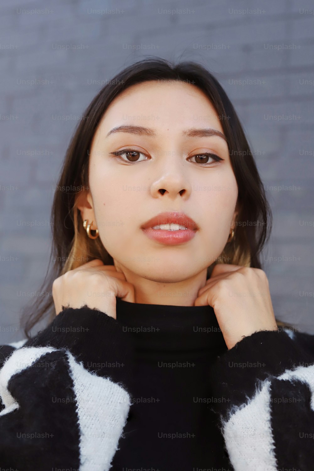 a woman wearing a black and white sweater