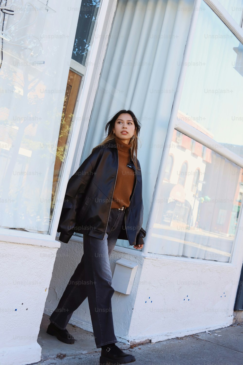 a woman is standing outside of a store