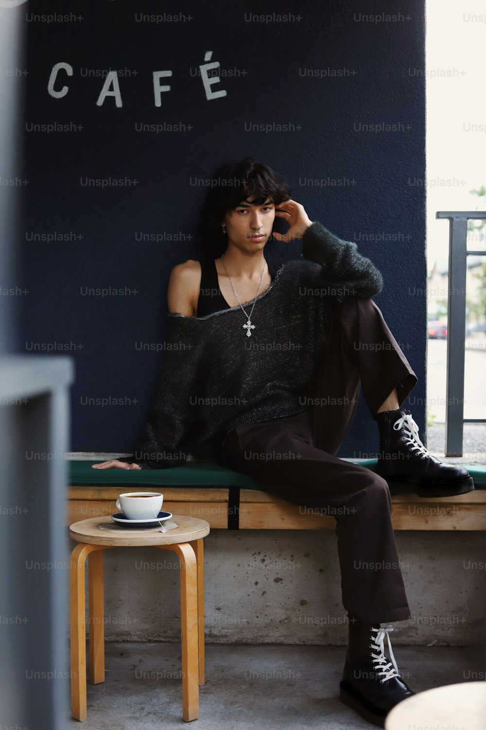 a woman sitting on a bench in a cafe