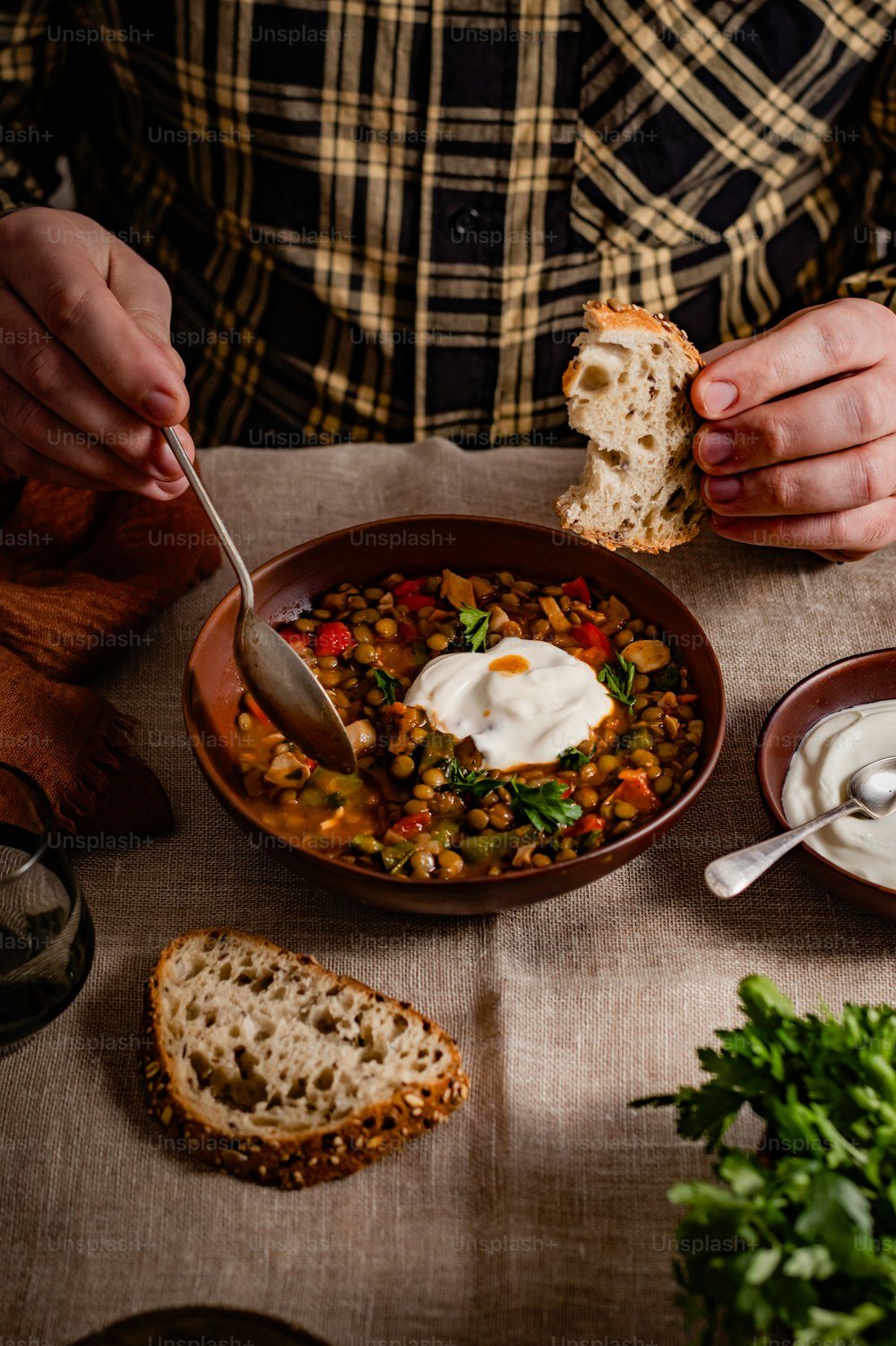 a person eating a bowl of food with a spoon