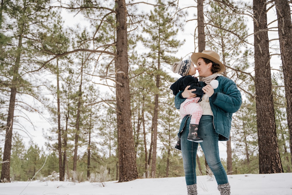 a woman holding a baby in the snow