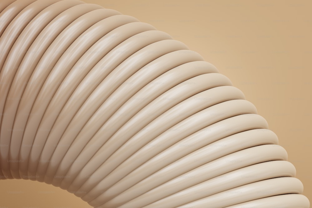 a close up of a white object with a beige background
