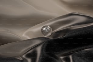 a drop of water sitting on top of a black cloth