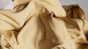 a beige fabric with a white ball on top of it