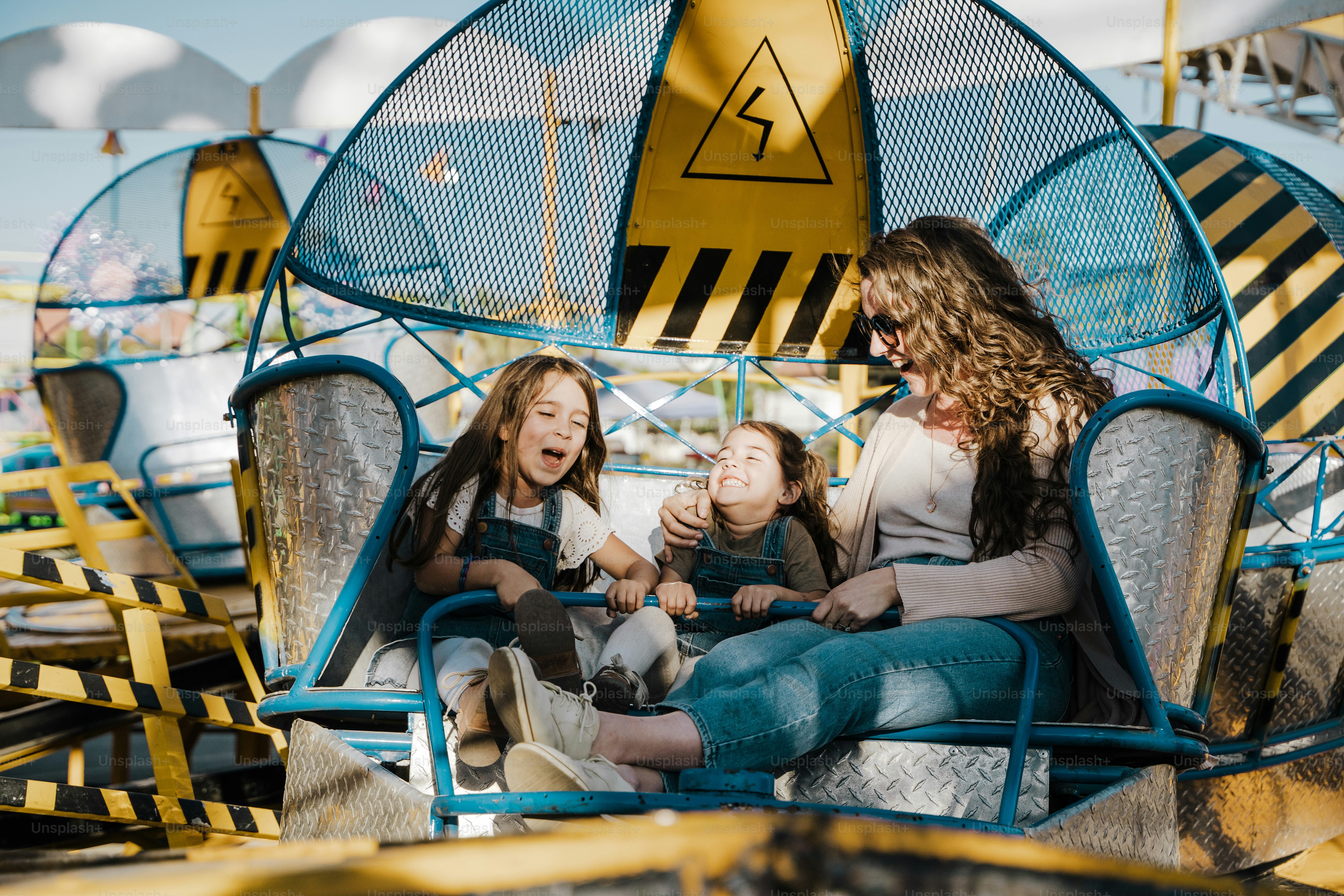 a group of people riding a roller coaster at a carnival