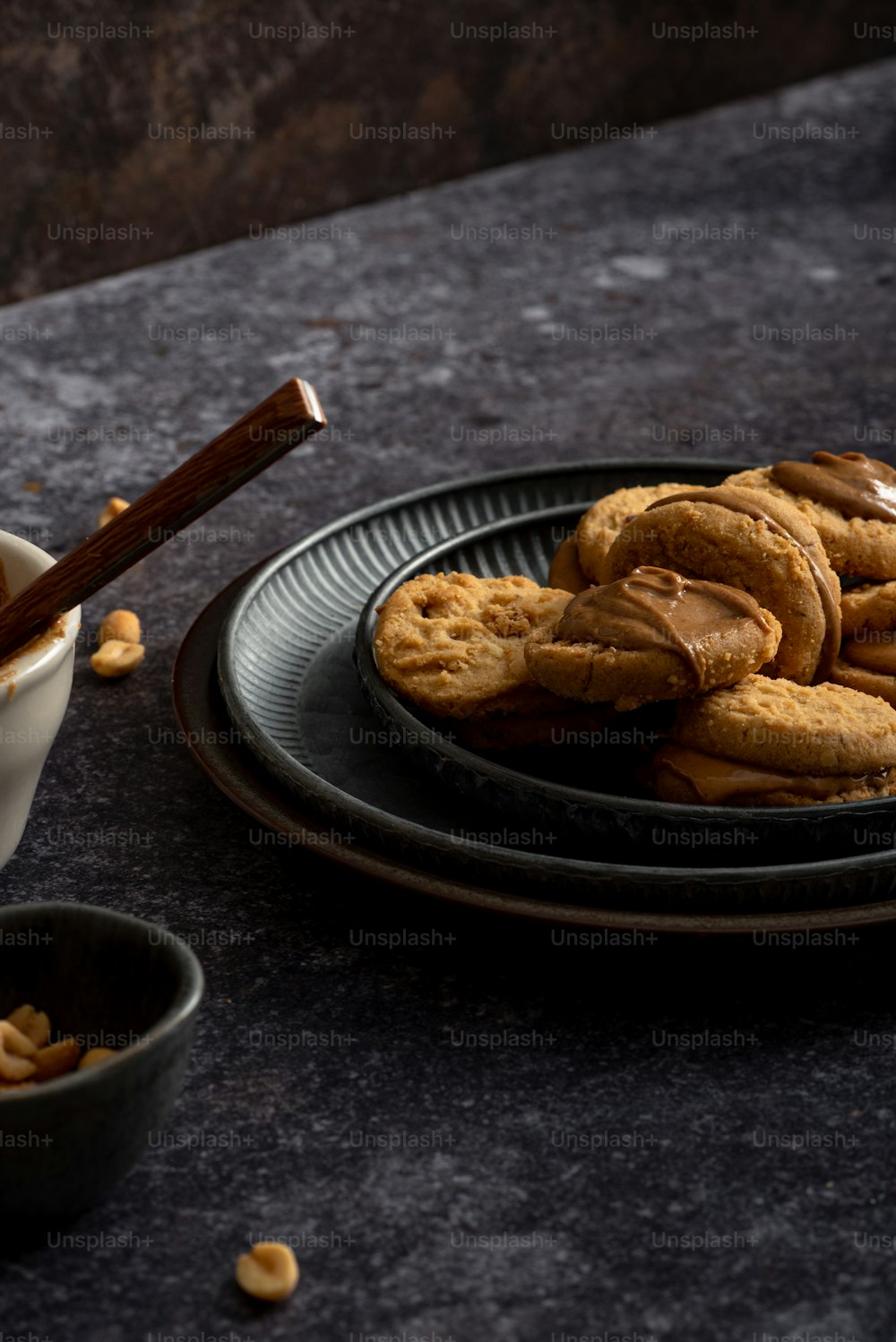 a plate of cookies next to a bowl of nuts