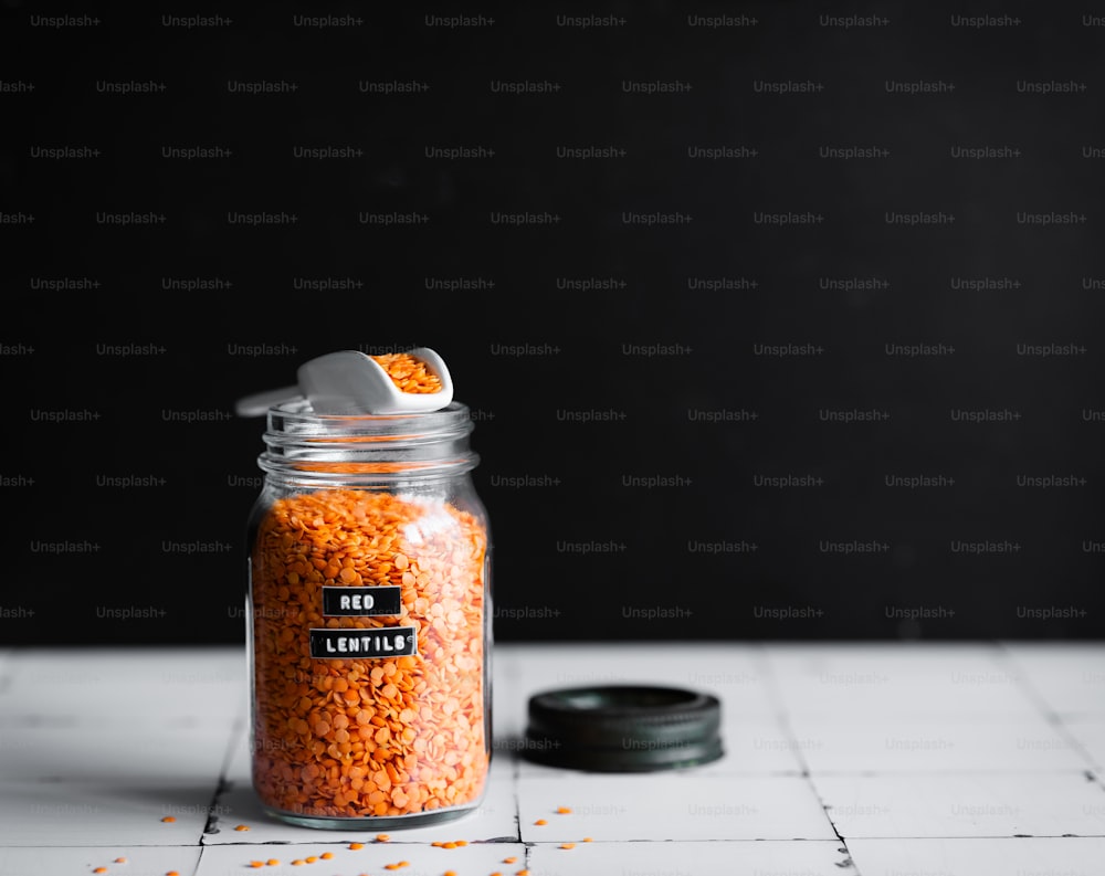 a glass jar filled with lots of red lentils