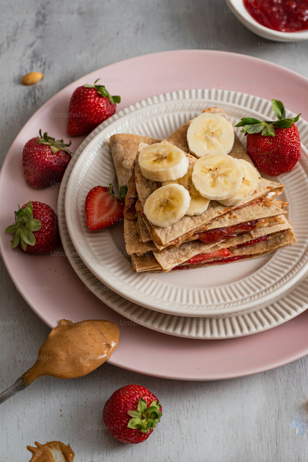 a plate of food with bananas and strawberries on it