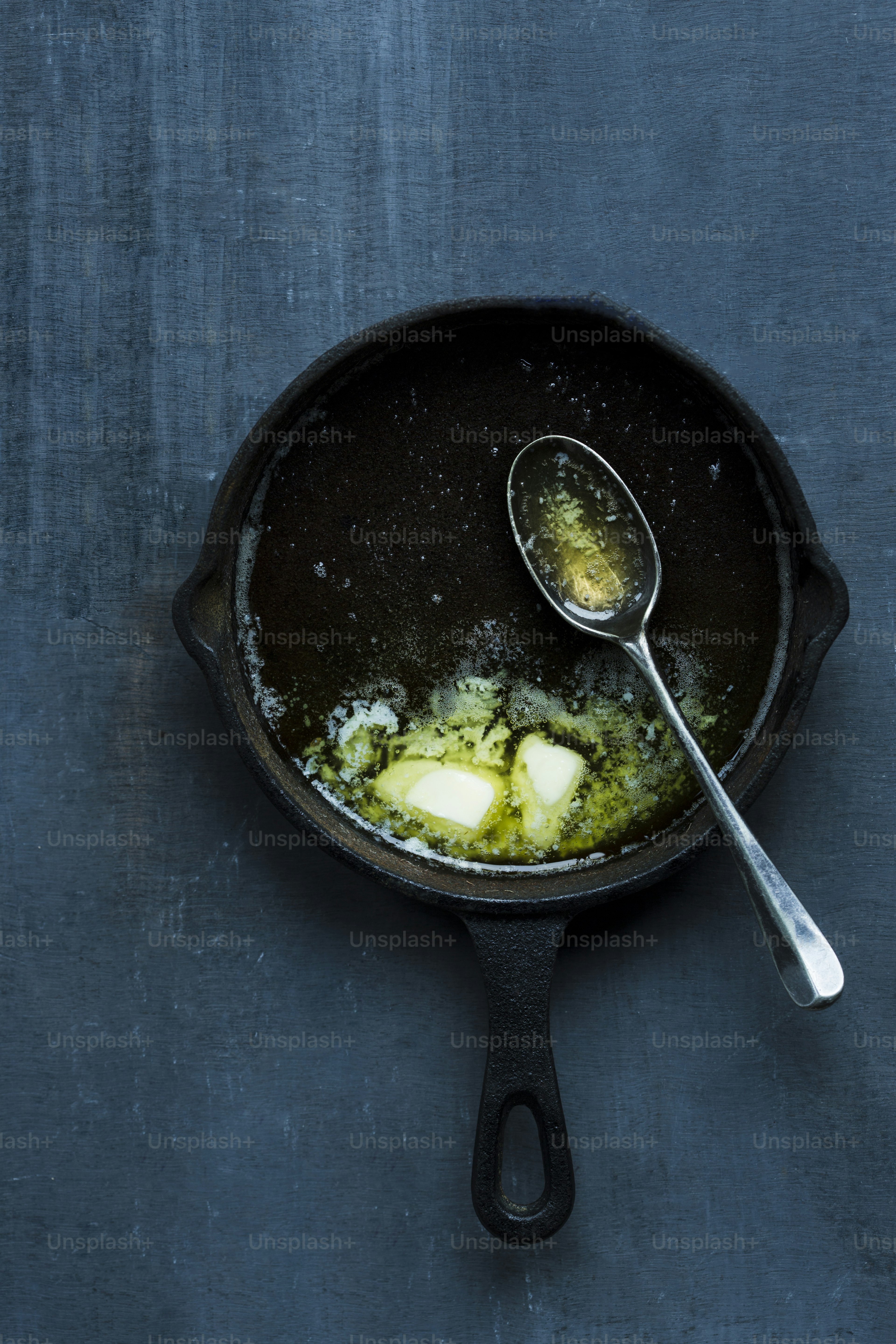 A frying pan filled with eggs and a spoon photo – Butter Image on Unsplash