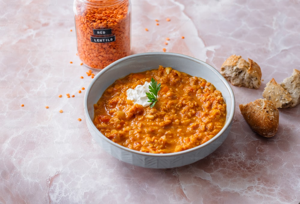 a bowl of food next to a jar of food